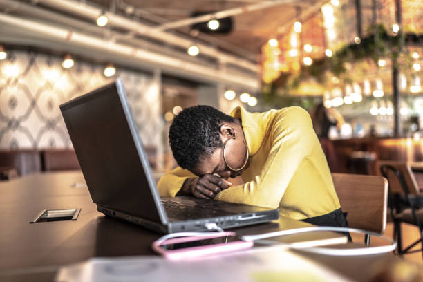 istock Tired young businesswoman working at office 1208391703