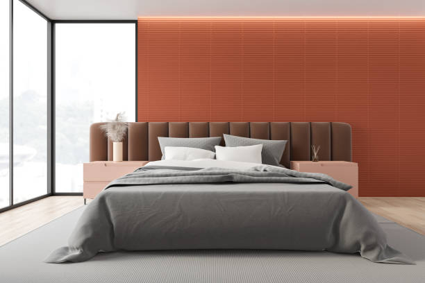 istock Orange master bedroom with brown bed 1208392599