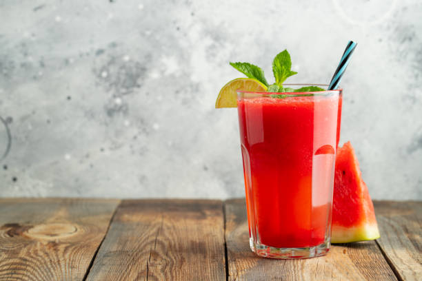istock Watermelon slushie with lime and mint, summer refreshing drink in tall glasses on a light blue background. Sweet cold smoothie with copy space 1208393992