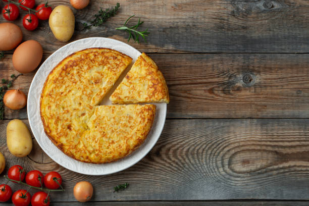 istock Spanish omelette with potatoes and onion, typical Spanish cuisine. Tortilla espanola. Rustic dark background. Top view with copy space 1208394072