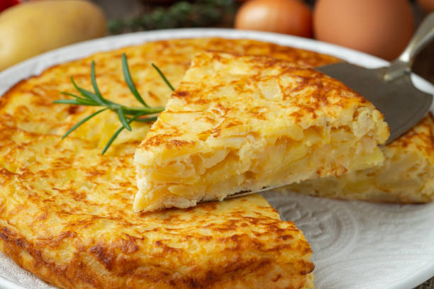 istock Spanish omelette with potatoes and onion, typical Spanish cuisine. Tortilla espanola. Rustic dark background 1208394117