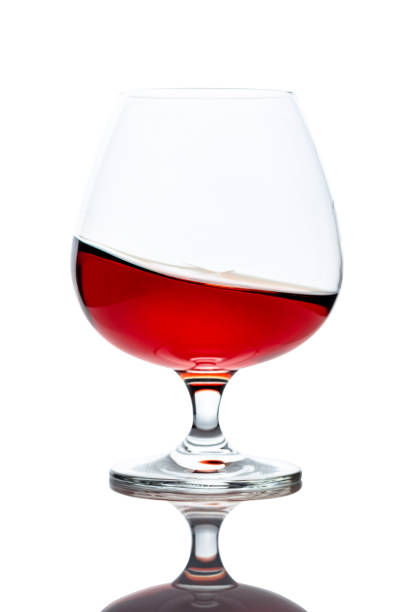istock Splash of cognac in glass, isolated on white. 1208394183