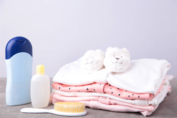 istock Baby clothes with a shower accessories on a grey background 1208394351