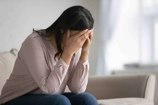 istock Upset biracial woman sit on couch feeling stressed at home 1208397353