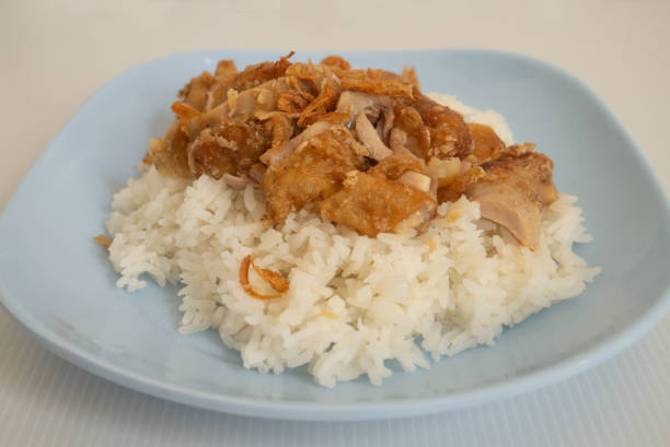 Rice with deep fried chicken drumstick topped with fried onion served as delicious food Asian style Rice with deep fried chicken drumstick topped with fried onion served as delicious food Asian style drumstick stock pictures, royalty-free photos & images