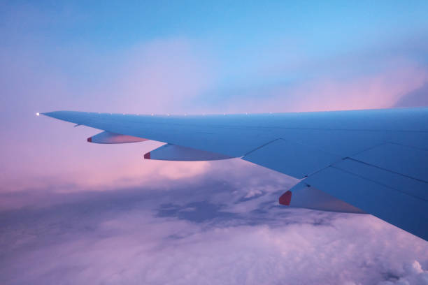 istock Colorful fluffy clouds and dawn sky with blurred an airplane wing and beautiful high view 1208398401