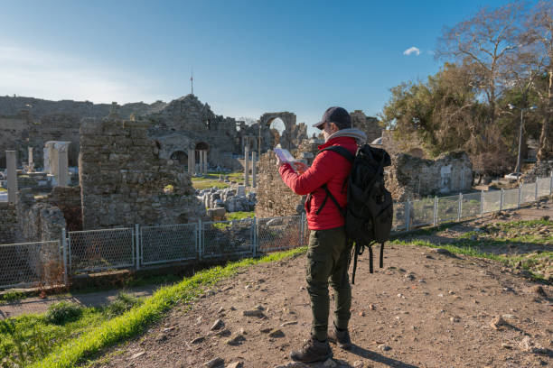 istock Travel man in looking at a map 1208398504