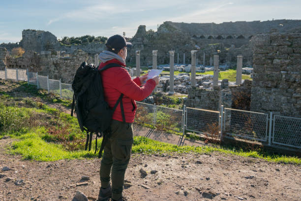 istock Travel man in looking at a map 1208398600