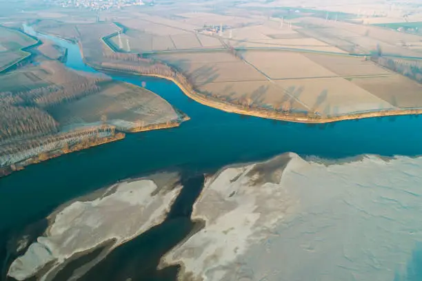 Aerial view of the Po river at the confluence with the Lambro river. Plain landscape in Lombardy (Italy).