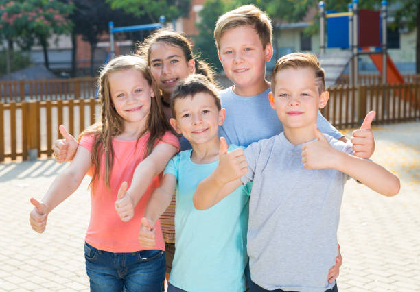 istock Kids posing at the playground and thumbs up 1208403345