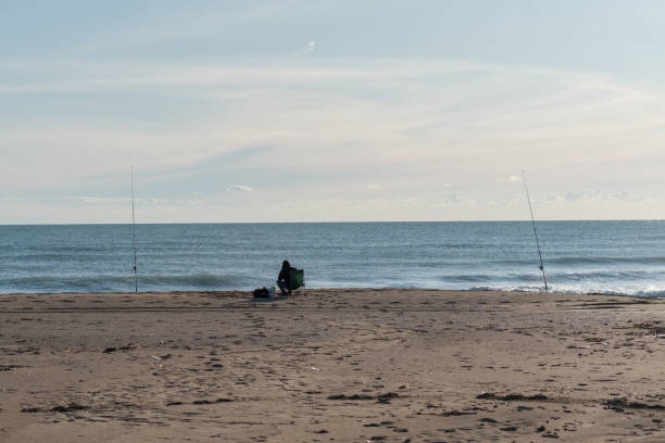 Fisherman on the sunny beach