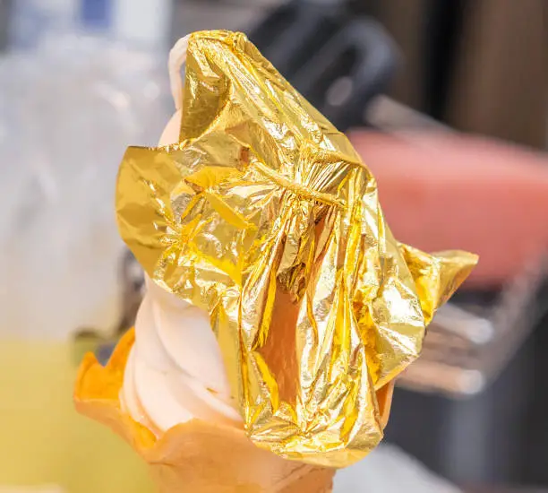 Photo of Hand is holding a golden leaf ice cream the signature ice cream of Kanazawa, Japan.