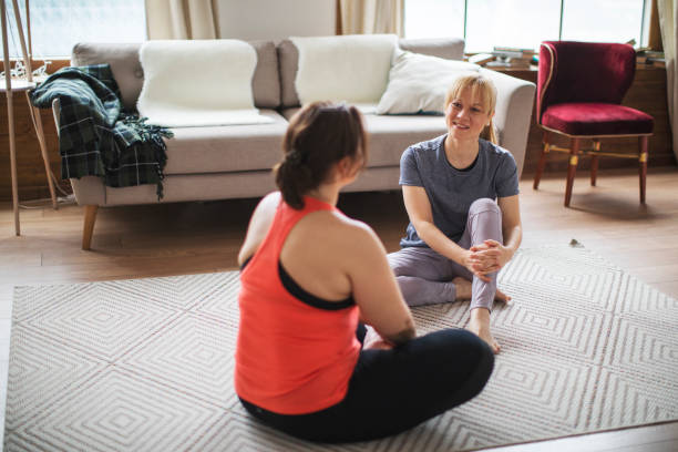 istock Two young women practicing yoga together 1208403855