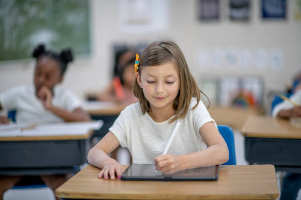 istock Elementary Girl Working on a Tablet stock photo 1208405279