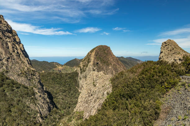 Panoramic view of Rocks - Los Roques in La Gomera island. A volcanic plug, also called a volcanic neck or lava neck, is a volcanic object created when magma hardens within a vent on an active volcano. vista panorámica de las rocas - los roques en la isla de la gomera. un tapón volcánico, también llamado cuello volcánico o cuello de lava, es un objeto volcánico creado cuando el magma se endurece dentro de un respiradero en un volcán activo