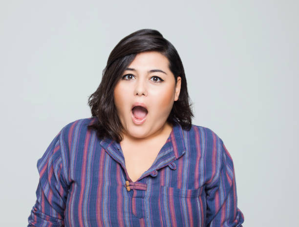istock Surprised young woman making a face 1208407598
