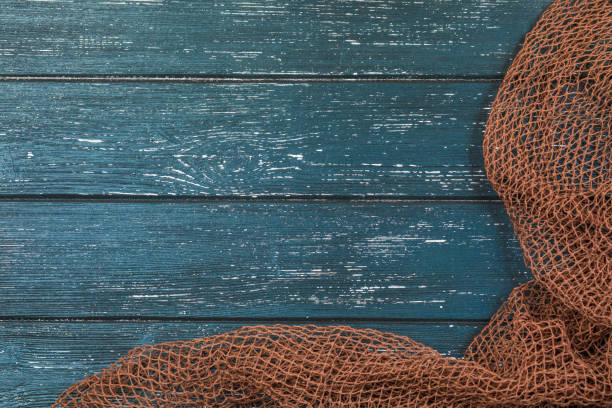 istock Wooden background with old fishing net. 1208409945