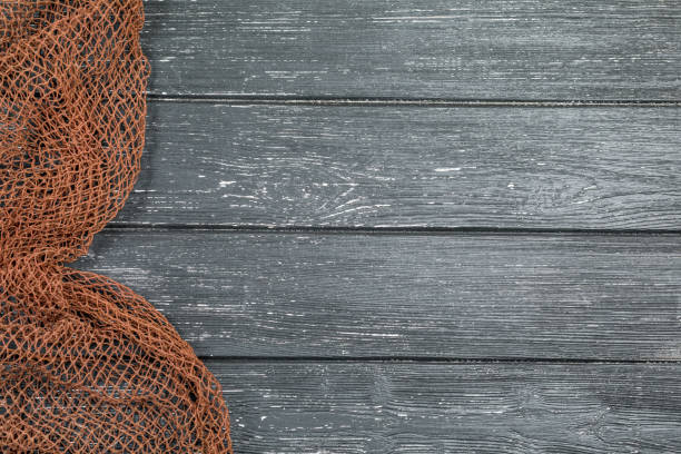istock Wooden background with old fishing net. 1208410131