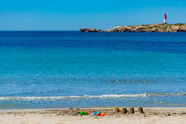 Photo of Crystal clear blue Mediterranean sea water on St.Croix Martigues beach and kids beach toys, Provence, France
