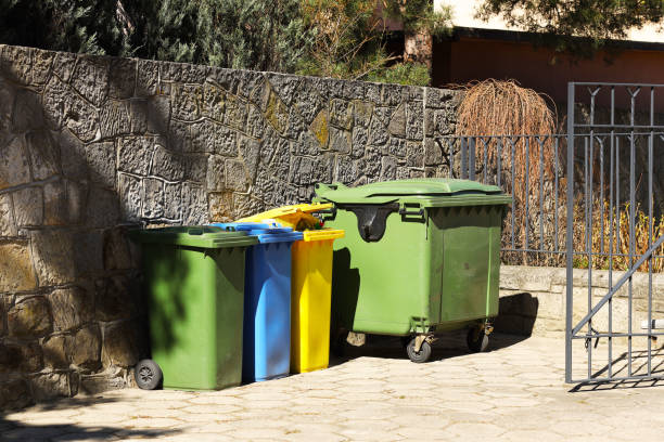 istock Four multicolored boxes for sorted garbage: green, blue and yellow. Recycling garbage in the tourist area. Infrastructure of the Mediterranean marina. Plastic waste containers 1208410274