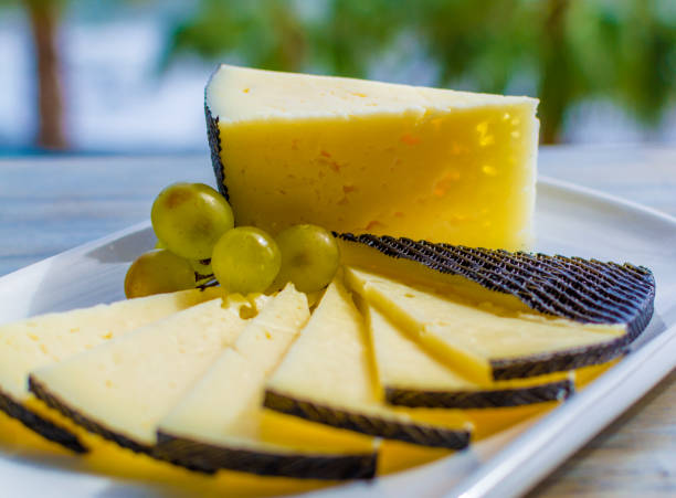 istock Spanish sheep cheese served with white grapes outside with sea view 1208413207