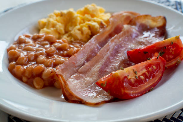 istock English breakfast with grilled bacon, tomatoes, scrambled eggs and baked beans in tomato sauce 1208413262