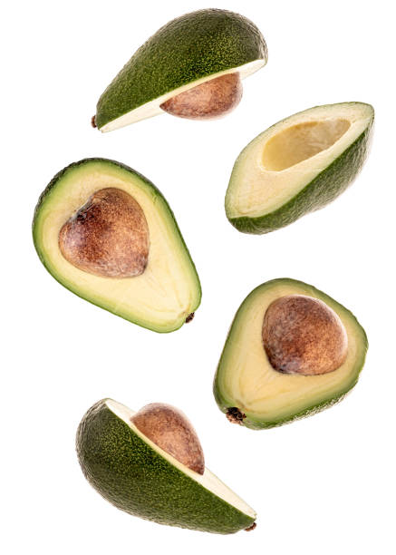 istock halved avocadoes flying isolated on white background 1208413434