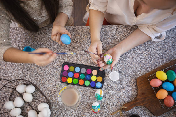 istock Young Family Painting Easter Eggs 1208413454