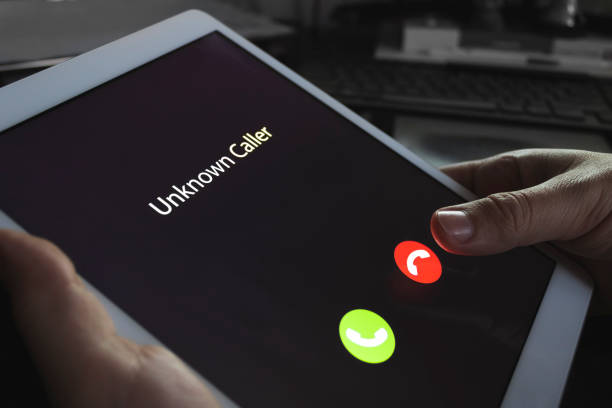 istock Unknown caller. A man holds a tablet in his hand and thinks to end the call. Incoming from an unknown number at night. Incognito or anonymous 1208414180