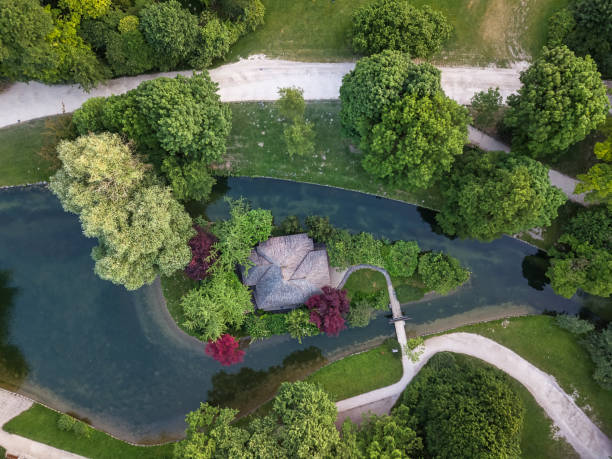 istock Aerial view over a park, canal with coloRed trees. 1208414223
