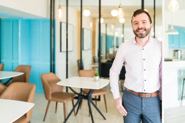 istock Businessman Smiling While Standing In Office 1208414261