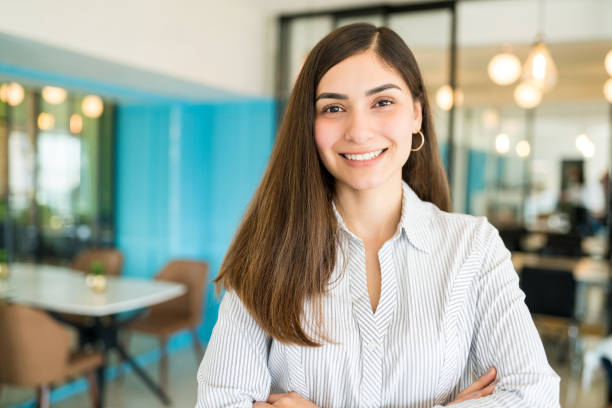 istock Female Employee Smiling In Office 1208414492