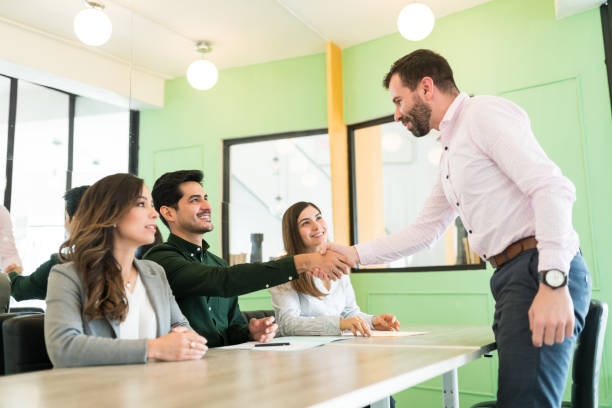istock Male Candidate Greeting Recruiters At Job Interview 1208415887