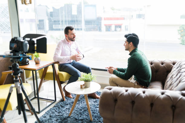 istock Journalist Interviewing Businessman In Workplace 1208416239