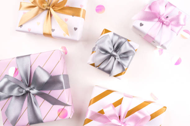istock Set of gift boxes with bows and confetti on a white background. 1208416392