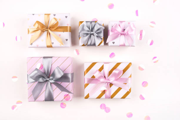 istock Set of gift boxes with bows and confetti on a white background. 1208416409