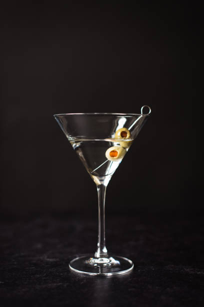 istock Close up of a classic martini cocktail against a black background. 1208417063