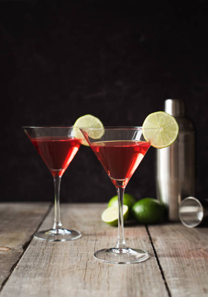 istock Two cosmopolitan martini drinks and ingredients on wooden table. 1208417098