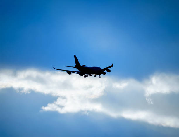 istock Silhouette passenger plane against the sky 1208417160