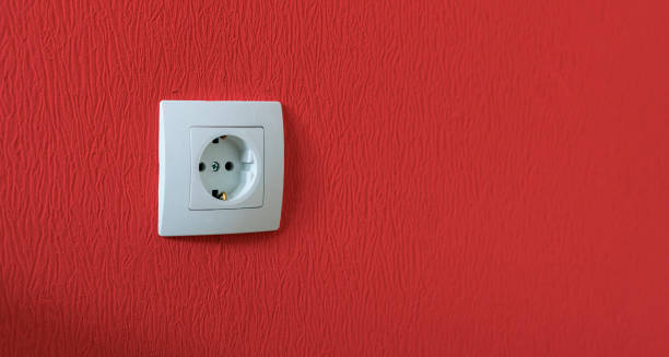 istock simple single white electricity socket in the wall at home apartment 1208417262