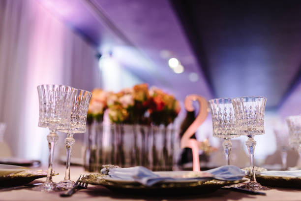 istock Serving guests, setting table. Two plates, silverware cutlery, glass, napkin. Wedding table decoration. Side view. Close up. 1208418125