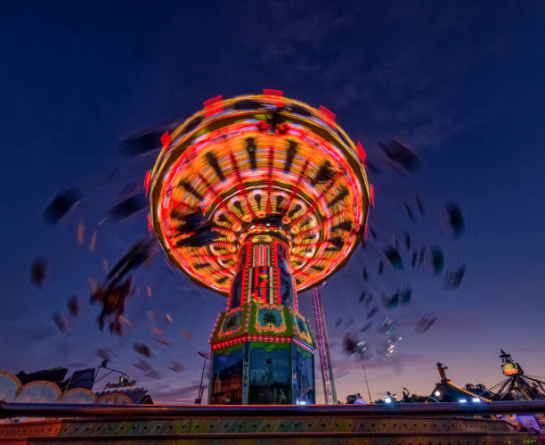 istock Chain carousel ride at evening hour from lower perspective. 1208418343