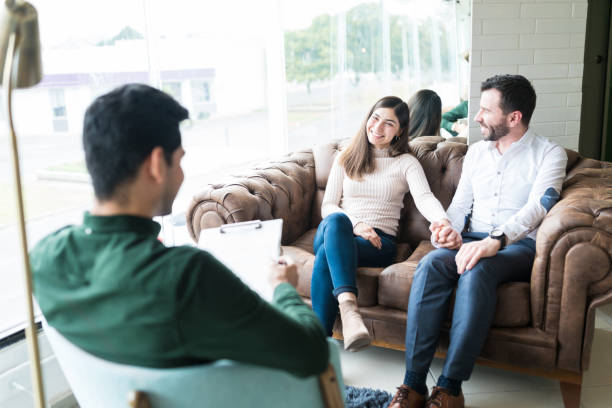 istock Smiling Husband And Wife Sitting Together During Therapy Session 1208419204