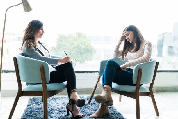 Sad Woman With Therapist In Office During Her Visit