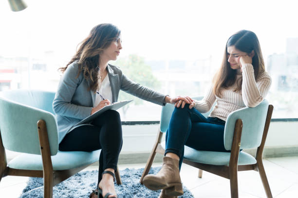 istock Therapist Giving Support To Crying Female Patient In Office 1208419423