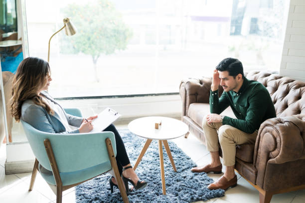 istock Therapist Guiding Sad Male Professional In Office 1208419831