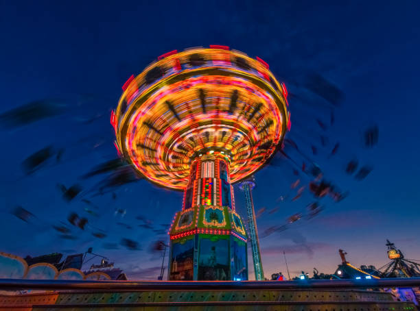 istock A rotation chain carousel illuminated with different bright colors. 1208421488
