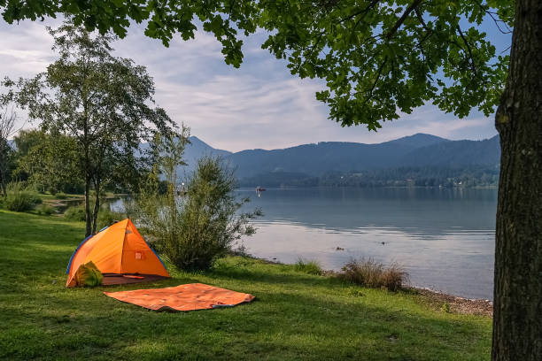 istock Tent by the idyllic lake with nobody inside. 1208422877