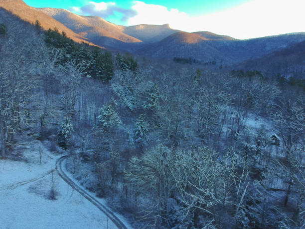 Aerial Drone snowy winter view of Blue Ridge Mountains in Asheville, North Carolina. Snow in the Appalachian Mountains. stock photo
