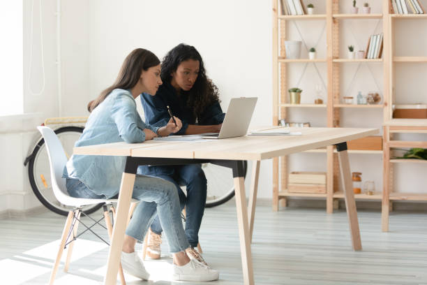 istock Young mixed race coworkers working on startup project. 1208424259